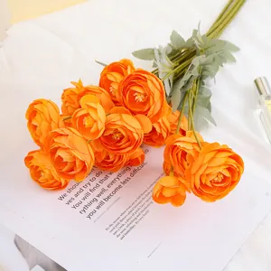 Close-up detail of vibrant orange artificial tea roses bouquet, perfect home decor prop.
