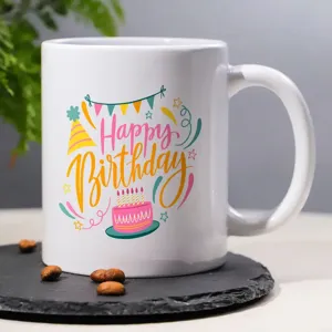Close-up of a white ceramic coffee mug with colorful birthday party illustration design.
