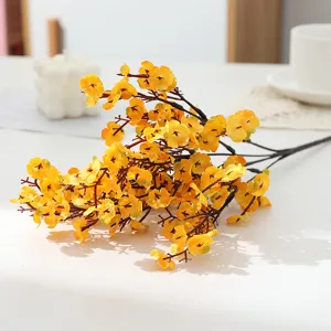 Artificial yellow flower branch detail view, perfect for home decor and floral arrangements.