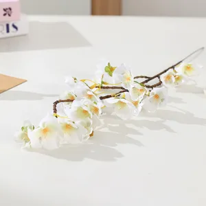 Artificial white cherry blossom branch close-up, premium faux flower stem for home and wedding.