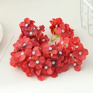 Detailed view of artificial red hydrangea flower heads for DIY crafts, headwear and gift boxes.