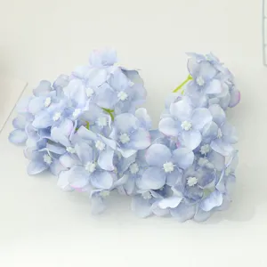 Artificial blue hydrangea flower heads close up for DIY crafts, wedding decor, and hair accessories.