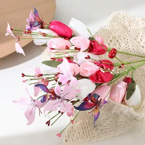 Detailed close-up of romantic pink artificial flower bouquet featuring tulips, roses and butterflies.