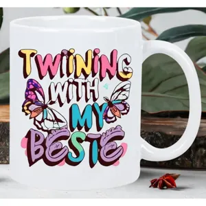 White ceramic coffee mug with cute butterfly and bestie text print, ideal for office use.