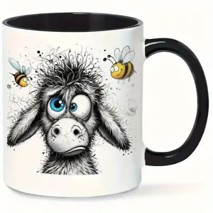 Close-up detail of the ceramic mug featuring a funny messy-haired animal graphic and bees.