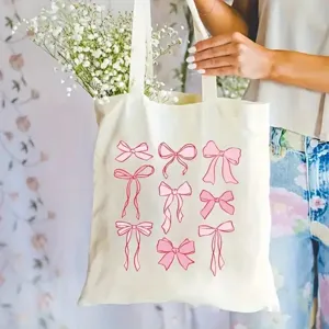 Beigefarbene Segeltuchtasche mit pinken Schleifen, lässige Einkaufstasche Detail.