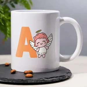 Close up of white ceramic coffee mug with cute angel and letter print, detail view on slate.