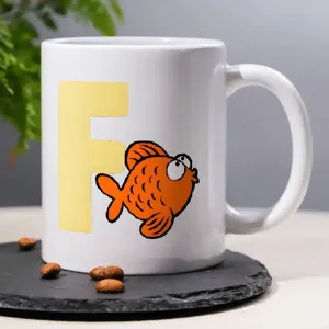 White ceramic coffee mug featuring a cute cartoon orange goldfish and yellow letter design.
