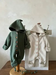 Detailed view of cozy baby fleece dinosaur hooded romper showing texture and cute buttons.