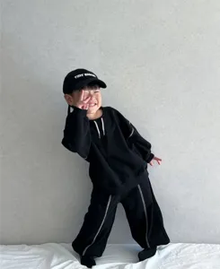Kids spring black hoodie and pants set, children casual sportswear with contrast stitching details.