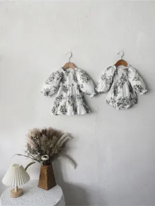 Floral baby girl long sleeve romper and dress set detail, vintage floral design with smocked bodice.