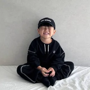 Boys spring sweatshirt set with drawstring and quilting, casual two-piece outfit with cap.