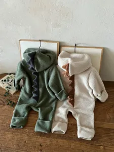 Detailed view of cute dinosaur fleece baby jumpsuit with soft hood and dorsal spikes.
