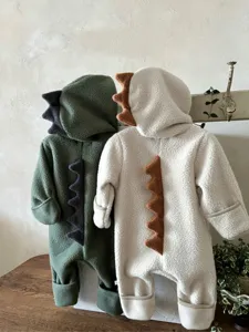 Detail shot of baby fleece dinosaur romper showcasing cute dorsal spikes and soft texture.