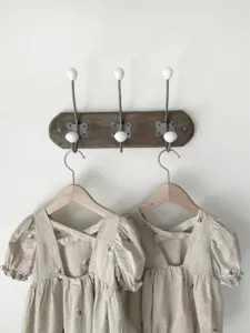 Detailed view of baby girl cotton embroidered romper with cute puff sleeves and bow back.