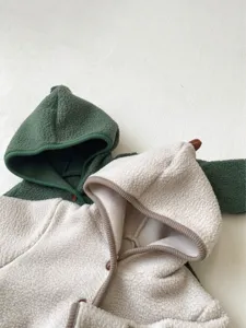 Infant fleece dinosaur hooded romper detail view, showing soft texture and cute spine hood.