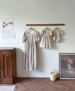 Charming embroidered linen baby romper and matching dresses set with puff sleeves and square collar.