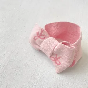 Cute pink knit baby headband with bow, soft infant hair accessory for daily wear and photos.