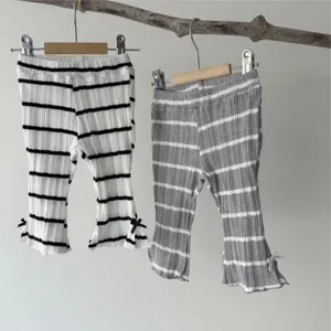 Infant ribbed striped flare pants detail, cute bow accent at cuff, soft knit toddler trousers.