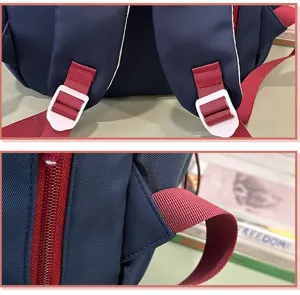 Vista detallada de una elegante mochila escolar azul marino con correas rojas y cremalleras.