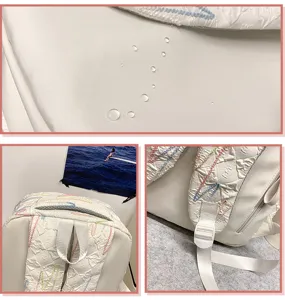 Detail view of the waterproof backpack featuring exquisite embroidery and durable fabric straps.