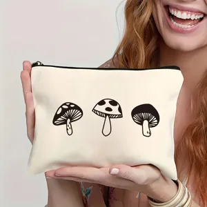 Détail en gros plan d'une trousse de maquillage blanche avec motif de champignons noirs.