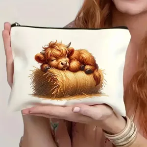Detailed view of a cute Highland cow print cosmetic pouch, perfect for everyday storage use.