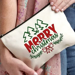 Canvas makeup bag featuring Christmas tree and merry christmas print in detail view.