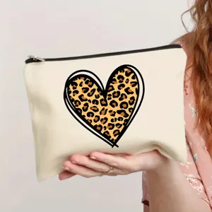 Close-up detail of a beige canvas makeup bag featuring a trendy leopard print heart design.