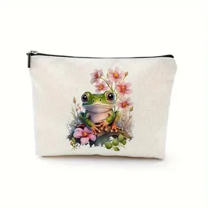 Close-up detail of white canvas cosmetic bag featuring cute watercolor frog and pink floral print.