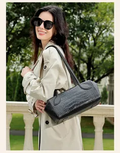 Detail shot of black crocodile pattern leather boston shoulder handbag for women commute daily use.