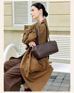 Elegant brown crocodile embossed boston shoulder bag, classic cylindrical commuter handbag.
