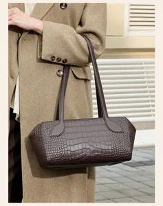 Detail view of a stylish brown crocodile pattern leather shoulder bag for women commute.