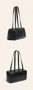 Detailed view of black crocodile embossed leather Boston shoulder bag with dual straps.