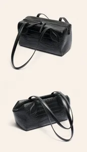 Black crocodile embossed leather Boston shoulder bag, stylish detail view of women handbag.