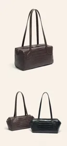 Detail view of crocodile embossed long shoulder bag, premium leather texture, dual straps.
