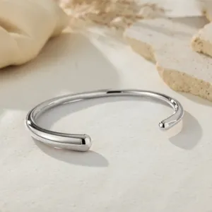Minimalist silver open cuff bracelet, smooth metal bangle detail shot for daily versatile style.