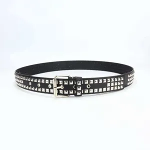 Punk rock style black leather belt detail featuring silver metal square pyramid studs.