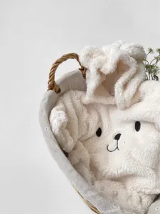 Detailed shot of cute bear hooded baby fleece romper, thick warm winter infant bodysuit closeup.