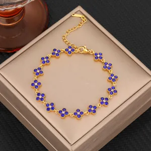 Luxury titanium steel clover bracelet with blue zirconia, elegant women jewelry accessory.