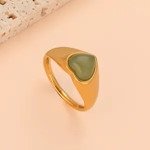 Close up detail shot of green heart gemstone titanium steel ring, simple fashion daily jewelry.
