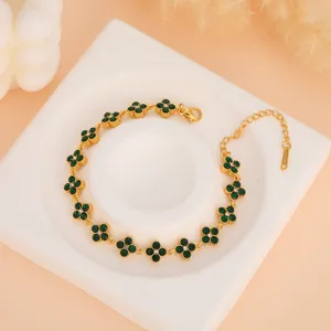 Gold-plated stainless steel bracelet featuring green zircon clover charms, elegant detail view.