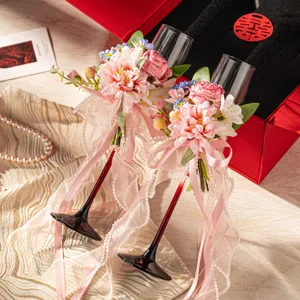 Wedding champagne flutes set with pink floral ribbon, elegant glassware for celebration