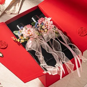 Wedding champagne glass gift set with pink floral ribbon decoration in red box for engagement.