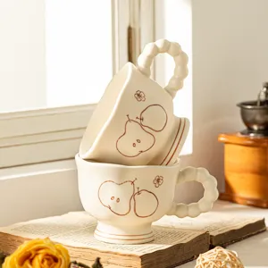 Vintage matte ceramic coffee mug with pear pattern and bead handle, elegant tableware main view.