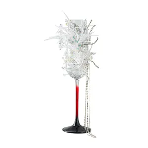 Elegant decorative champagne glass with white feathers, pearls, rhinestones, and gradient stem.