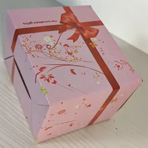Pink paper gift box with red ribbon print, ideal for packaging presents, elegant and stylish design.
