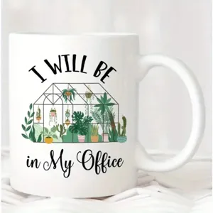 White ceramic office coffee mug detail showing greenhouse plant design quote print.