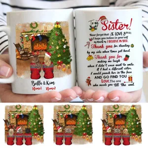 Customizable Christmas sister coffee mug with warm fireplace design and personalized names text.
