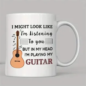 Nahaufnahme Detail der weißen Keramik-Kaffeetasse mit Gitarrengrafik und witzigem Spruch.